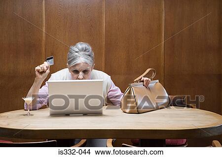 Senior woman internet shopping View Large Photo Image Picture - Senior woman internet shopping. Fotosearch