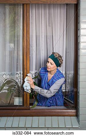 Woman dusting window frames View Large Photo Image Picture - Woman dusting window frames. Fotosearch