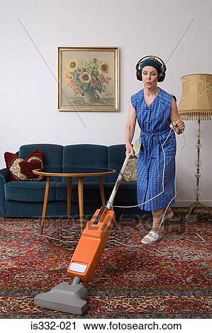 Woman wearing headphones and vacuuming View Large Photo Image Stock Image - Woman wearing headphones and vacuuming. Fotosearch