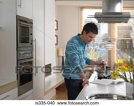 Man cooking in kitchen View Large Photo Image Stock Image - Man cooking in kitchen. Fotosearch