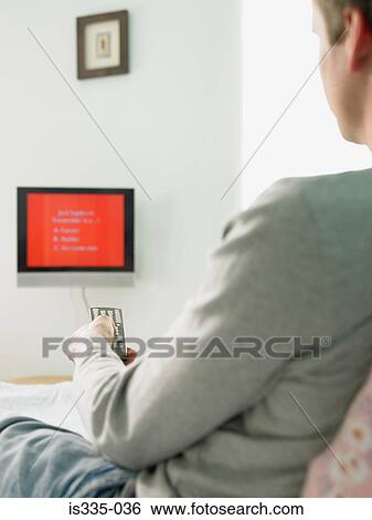 Man watching television at home View Large Photo Image Stock Photograph - Man watching television at home. Fotosearch