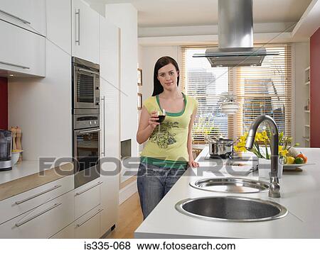 Stock Photo - Woman holding a glass of red wine. Fotosearch