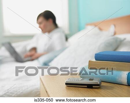 Woman using a laptop computer in bed View Large Photo Image Stock Image - Woman using a laptop computer in bed. Fotosearch