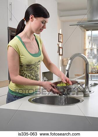 Woman washing grapes in kitchen sink View Large Photo Image Stock Image - Woman washing grapes in kitchen sink. Fotosearch