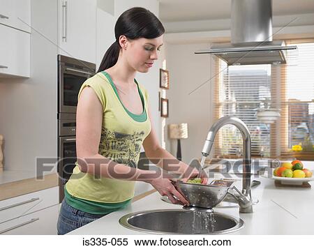 Woman washing grapes in kitchen sink View Large Photo Image Stock Photography - Woman washing grapes in kitchen sink. Fotosearch
