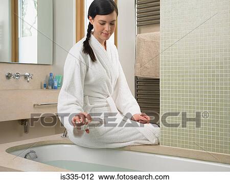 Young woman preparing a bath View Large Photo Image Stock Image - Young woman preparing a bath. Fotosearch