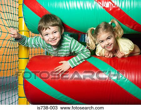 Boy and girl in soft play area View Large Photo Image Stock Image - Boy and girl in soft play area. Fotosearch