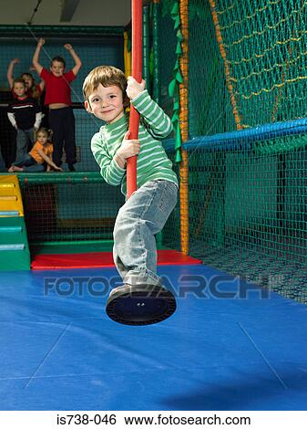 Stock Photograph - Boy on a swing. Fotosearch