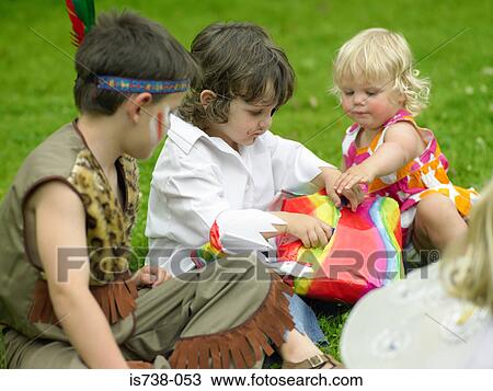 Stock Image - Children playing pass the parcel. Fotosearch