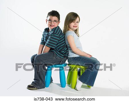 Girl and boy sitting on stools View Large Photo Image Stock Image - Girl and boy sitting on stools. Fotosearch