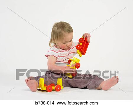 Girl playing with toy train View Large Photo Image Picture - Girl playing with toy train. Fotosearch