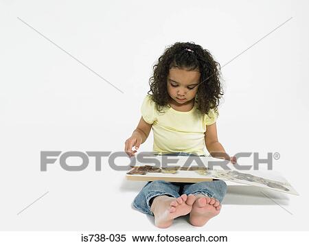 Girl reading a storybook View Large Photo Image Stock Photography - Girl reading a storybook. Fotosearch