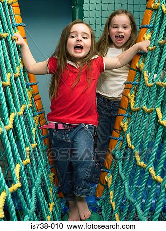 Girls playing on rope nets View Large Photo Image Stock Image - Girls playing on rope nets. Fotosearch