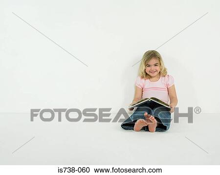 Stock Image - Little girl with picture book. Fotosearch