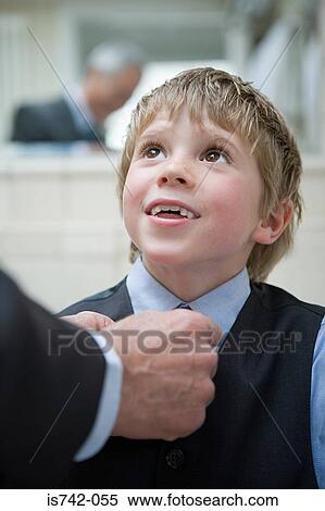 Boy having his tie adjusted View Large Photo Image Stock Photography - Boy having his tie adjusted. Fotosearch