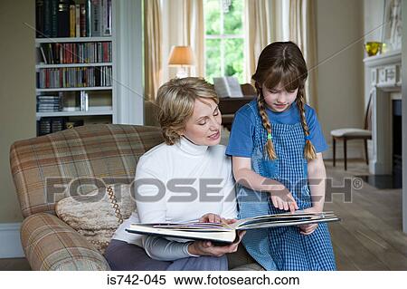 Girl and grandmother looking at scrapbook View Large Photo Image Stock Photography - Girl and grandmother looking at scrapbook. Fotosearch