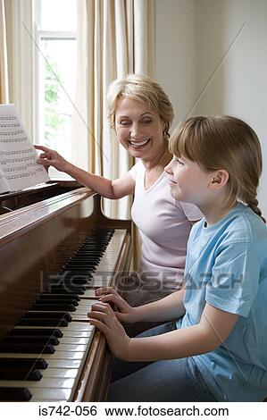 Girl and grandmother playing piano View Large Photo Image Stock Photograph - Girl and grandmother playing piano. Fotosearch