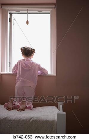 Girl looking out of window View Large Photo Image Stock Image - Girl looking out of window. Fotosearch