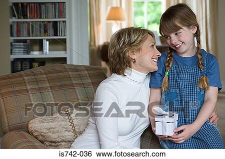Girl with present from grandmother View Large Photo Image Stock Photograph - Girl with present from grandmother. Fotosearch
