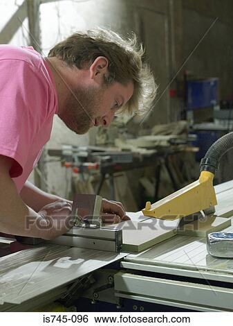 Carpenter using table saw View Large Photo Image Stock Photograph - Carpenter using table saw. Fotosearch