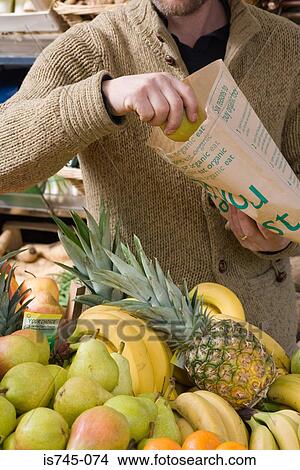 Man buying organic fruit View Large Photo Image Picture - Man buying organic fruit. Fotosearch