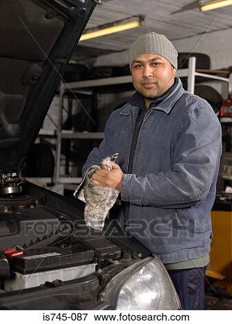 Mechanic wiping his hands View Large Photo Image Stock Photo - Mechanic wiping his hands. Fotosearch