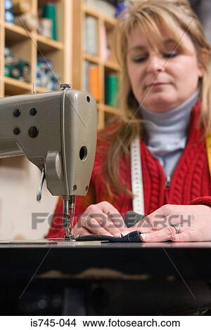 Picture - Seamstress sewing. Fotosearch
