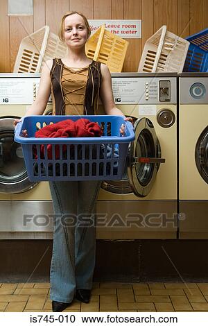 Woman holding laundry View Large Photo Image Stock Image - Woman holding laundry. Fotosearch