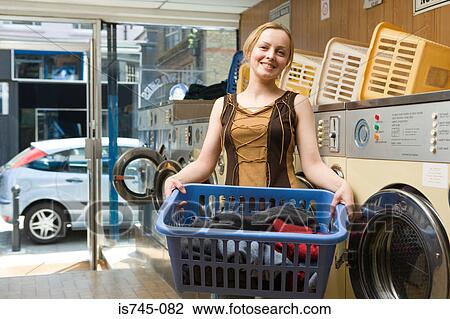 Stock Image - Woman holding laundry. Fotosearch