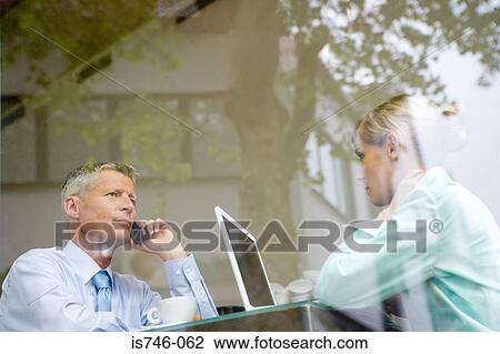 Business couple working at bar table, view through window View Large Photo Image Stock Image - Business couple working at bar table, view through window. Fotosearch