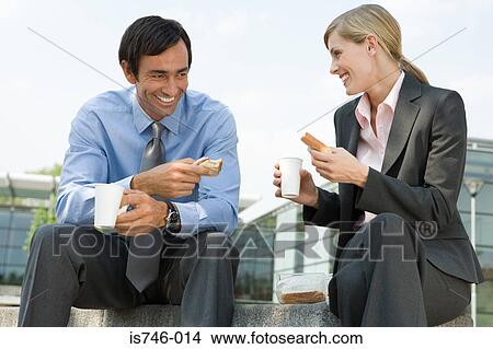 Businesswoman and businessman eating sandwiches outdoors View Large Photo Image Picture - Businesswoman and businessman eating sandwiches outdoors. Fotosearch
