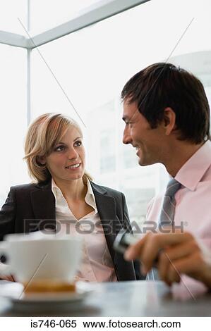 Stock Photography - Businesswoman and businessman having coffee break. Fotosearch