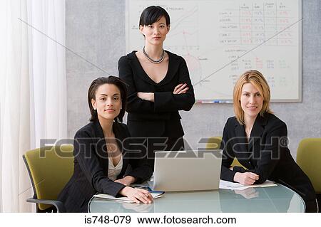 Stock Photo - Three young women conference room. Fotosearch