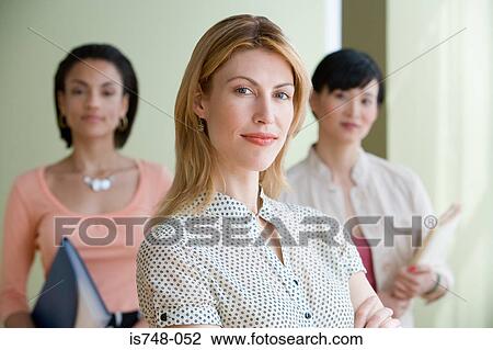 Three young women posing indoors View Large Photo Image Stock Image - Three young women posing indoors. Fotosearch
