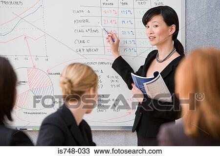Stock Image - Young woman giving lecture. Fotosearch