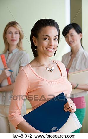 Young woman holding folder View Large Photo Image Stock Image - Young woman holding folder. Fotosearch