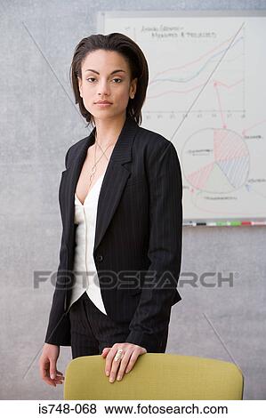Young woman posing in conference room View Large Photo Image Stock Photo - Young woman posing in conference room. Fotosearch