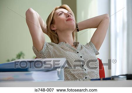 Young woman relaxing at desk View Large Photo Image Stock Photo - Young woman relaxing at desk. Fotosearch