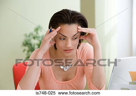Young woman sitting at desk View Large Photo Image Stock Photography - Young woman sitting at desk. Fotosearch