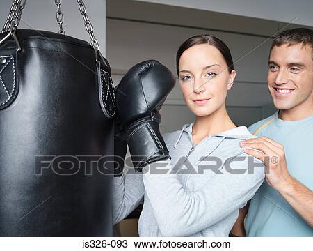 Instructor and young female boxer at punch bag View Large Photo Image Stock Image - Instructor and young female boxer at punch bag. Fotosearch