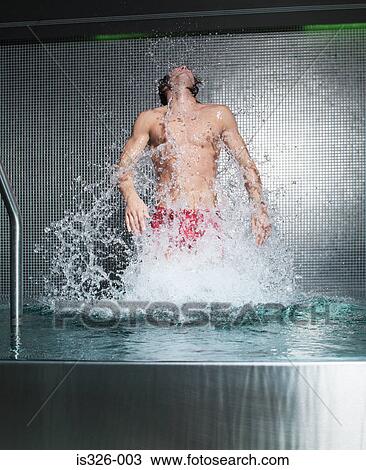 Stock Image - Man jumping in swimming pool. Fotosearch