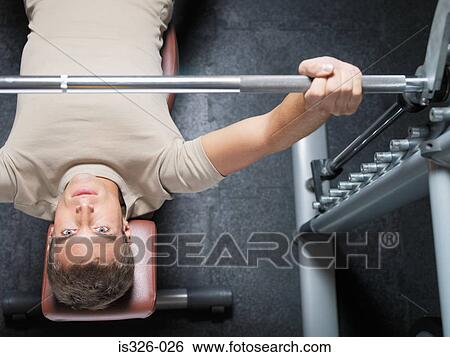 Man lifting barbell View Large Photo Image Stock Photograph - Man lifting barbell . Fotosearch