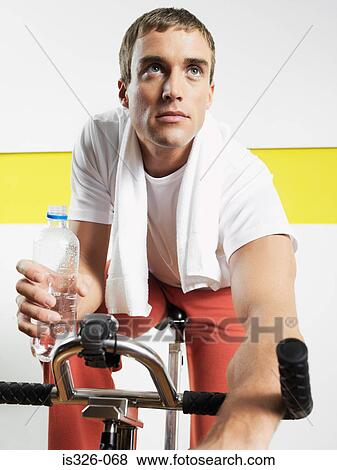 Man on exercise bike in health club View Large Photo Image Stock Photo - Man on exercise bike in health club . Fotosearch