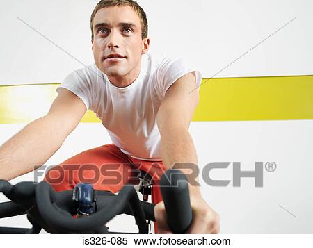 Man on exercise bike in health club View Large Photo Image Stock Photography - Man on exercise bike in health club . Fotosearch