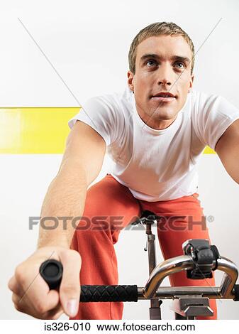 Man on exercise bike in health farm View Large Photo Image Stock Image - Man on exercise bike in health farm . Fotosearch