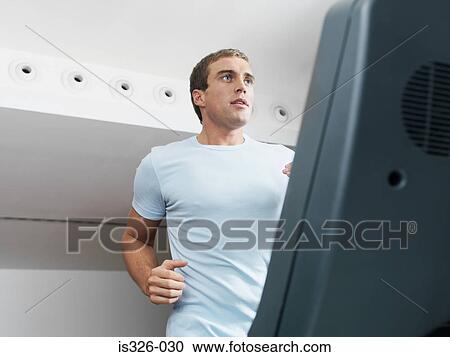 Man on treadmill in health club View Large Photo Image Stock Image - Man on treadmill in health club . Fotosearch