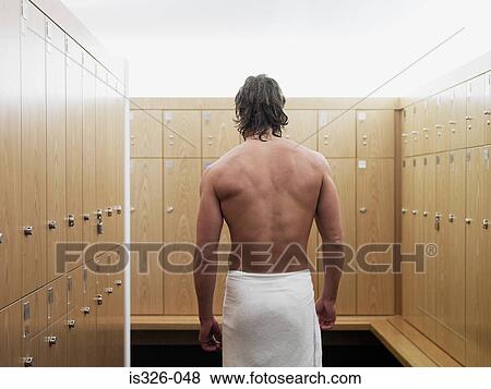 Stock Photo - Man standing in locker room in gym . Fotosearch