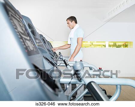 Mann on treadmill in health club View Large Photo Image Stock Photograph - Mann on treadmill in health club. Fotosearch