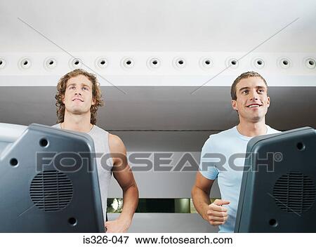 Stock Photo - Two men on treadmill in health club. Fotosearch