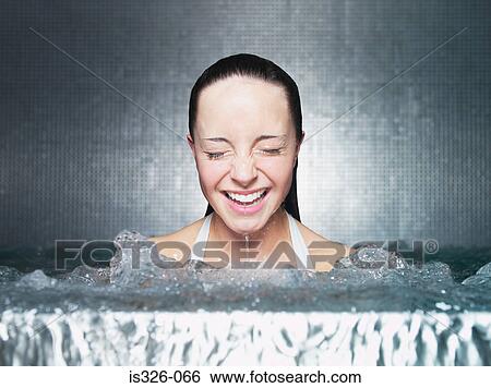 Stock Photograph - Woman immersing in jacuzzi. Fotosearch